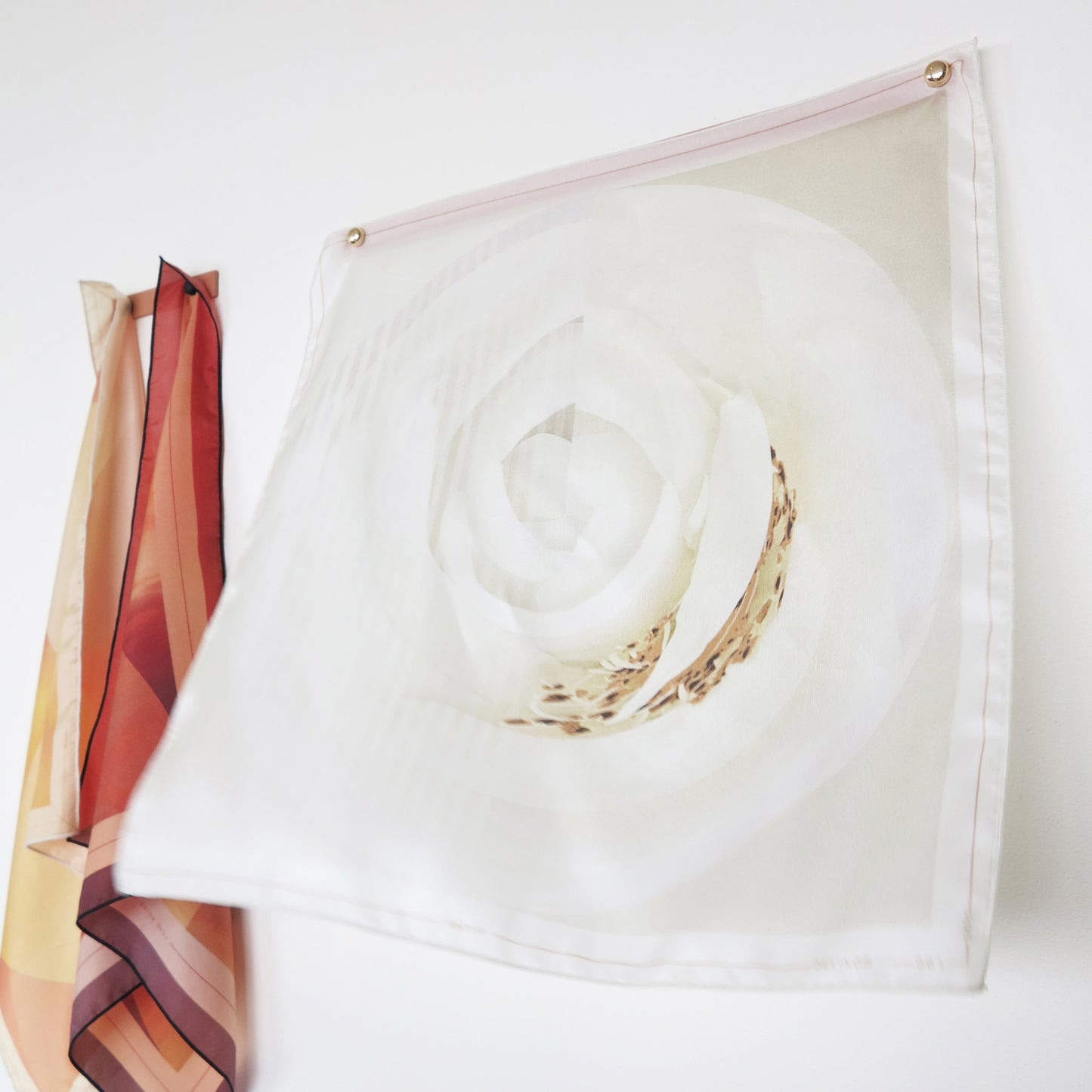 Delinor porte carre rose 15in Linea pink metal hanger for mural art showing Rosa Pax silk scarf 16in